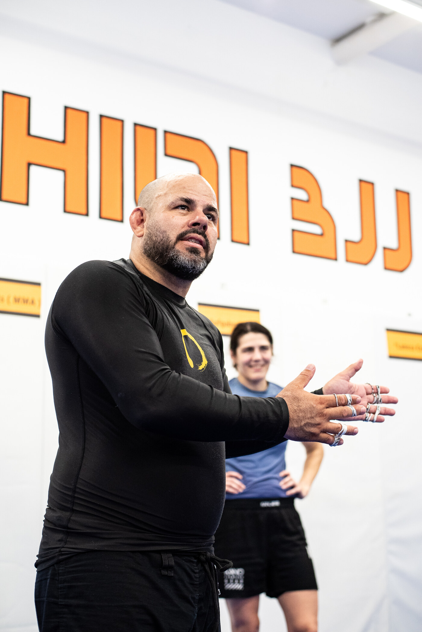 Frank Burczynski explaining a technique in front of the Hilti BJJ wall