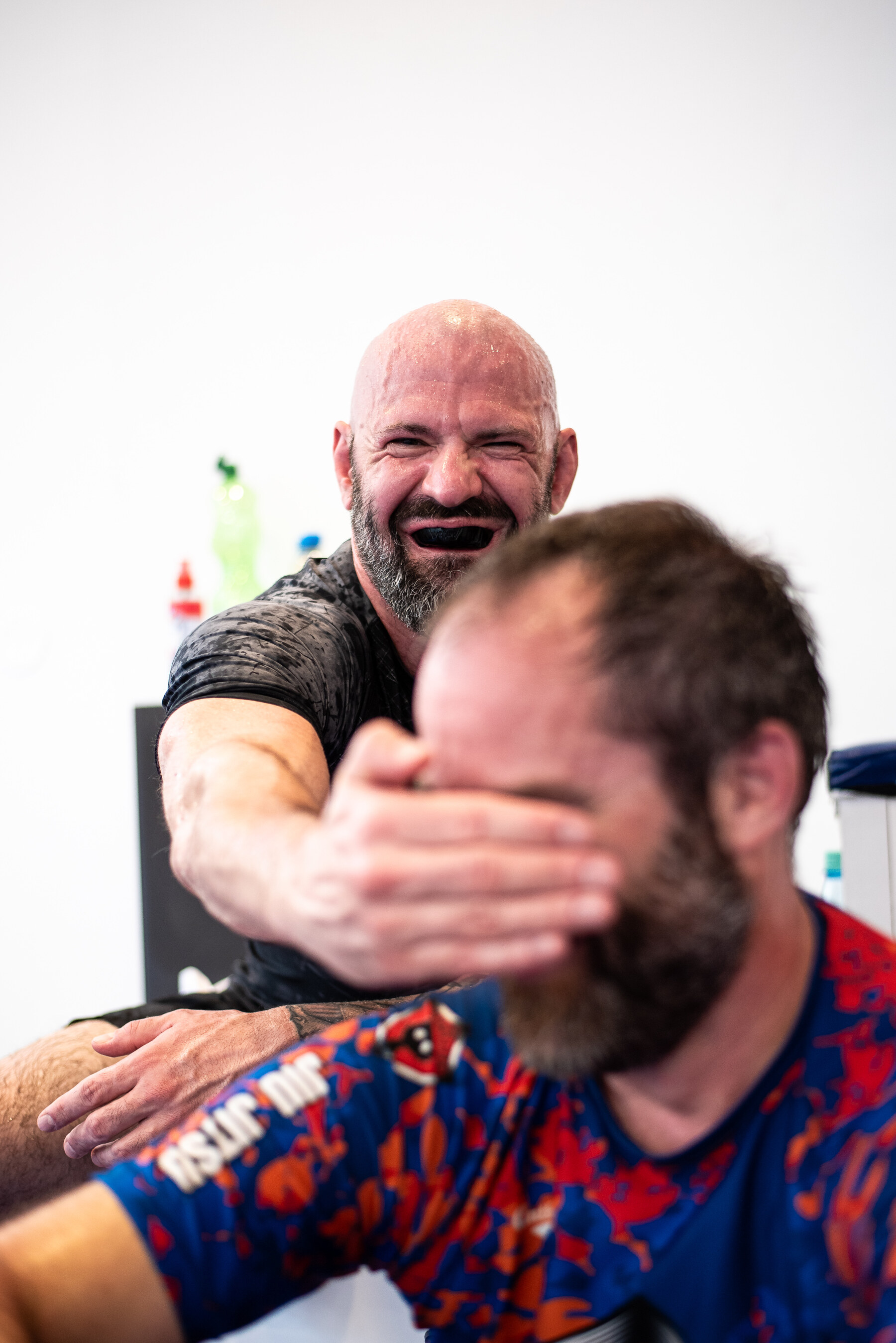 Two Hilti BJJ coaches laughing together after training